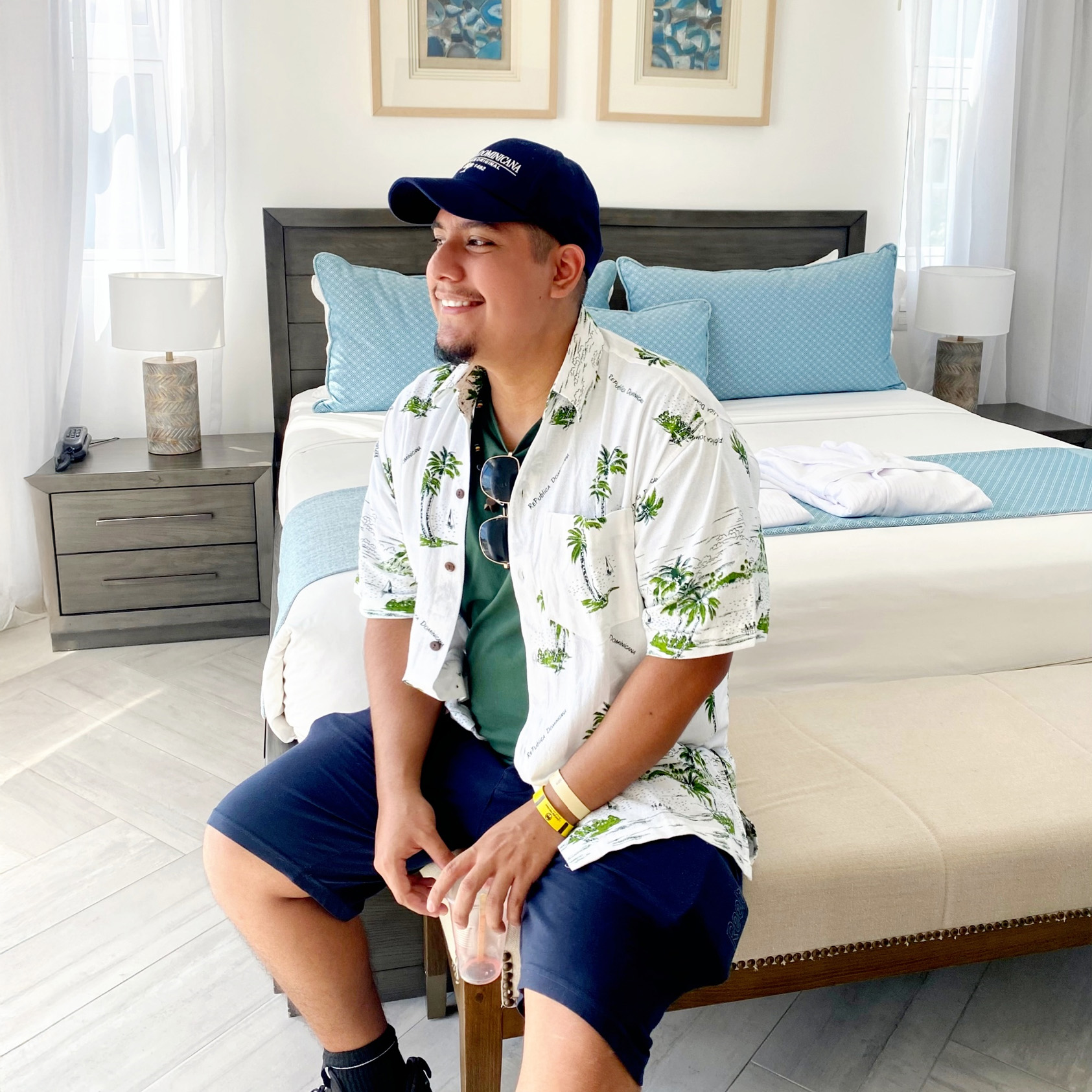 An image of a latin black haired boy dressed in a red flannel and light red shirt.